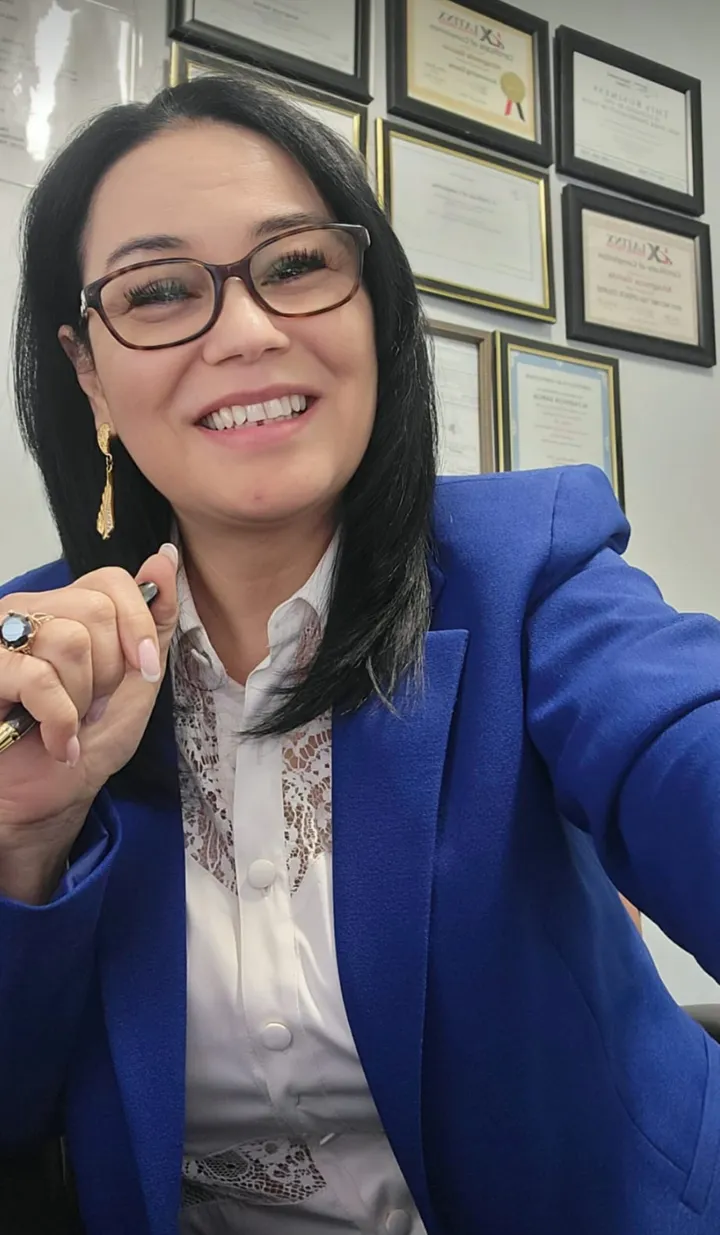 Altagracia Garcia smiling in the Dreams Tax office.